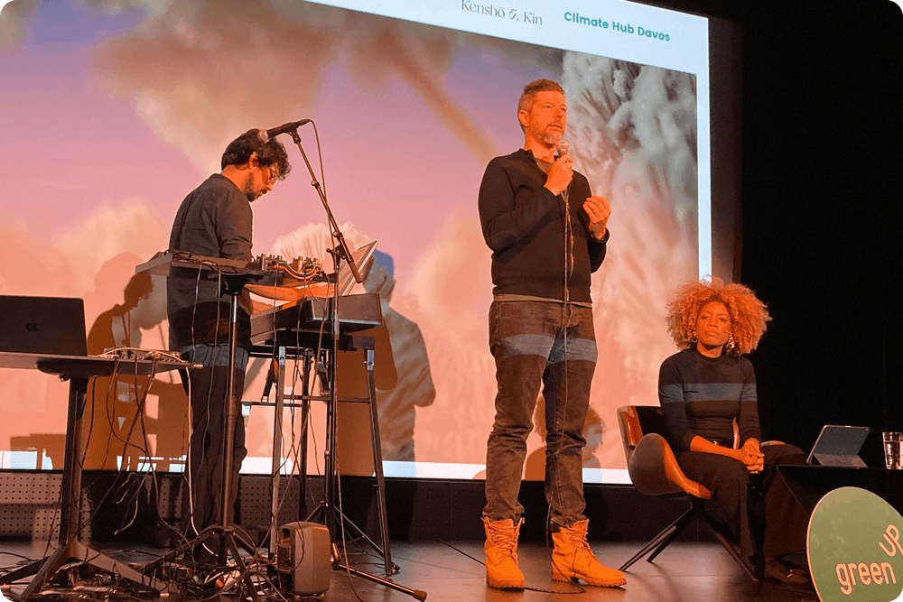 People standing on stage during meditation event