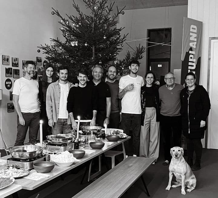 people standing in front of a christmas tree